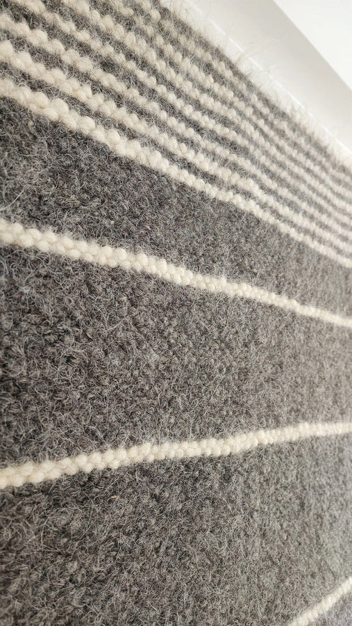 Berda rug — modern minimalist wool rug, charcoal gray with cream ivory stripes, eco-friendly handmade craftsmanship