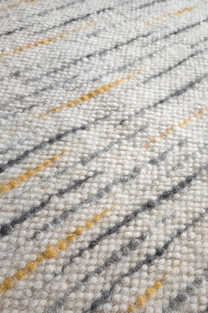 Hand-knotted undyed wool rug, ivory white base with gray and orange stripe details, refined natural home decor