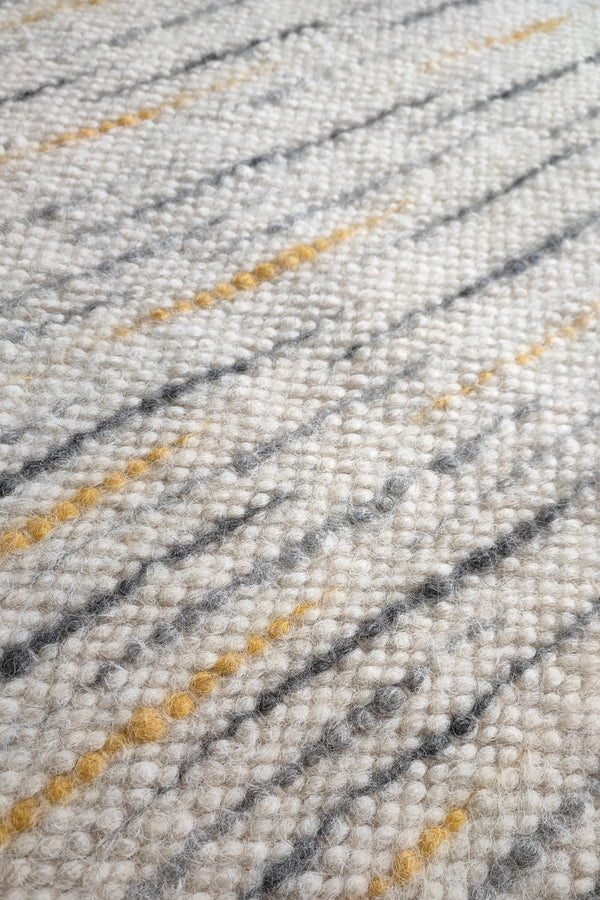 Hand-knotted undyed wool rug, ivory white base with gray and orange stripe details, refined natural home decor