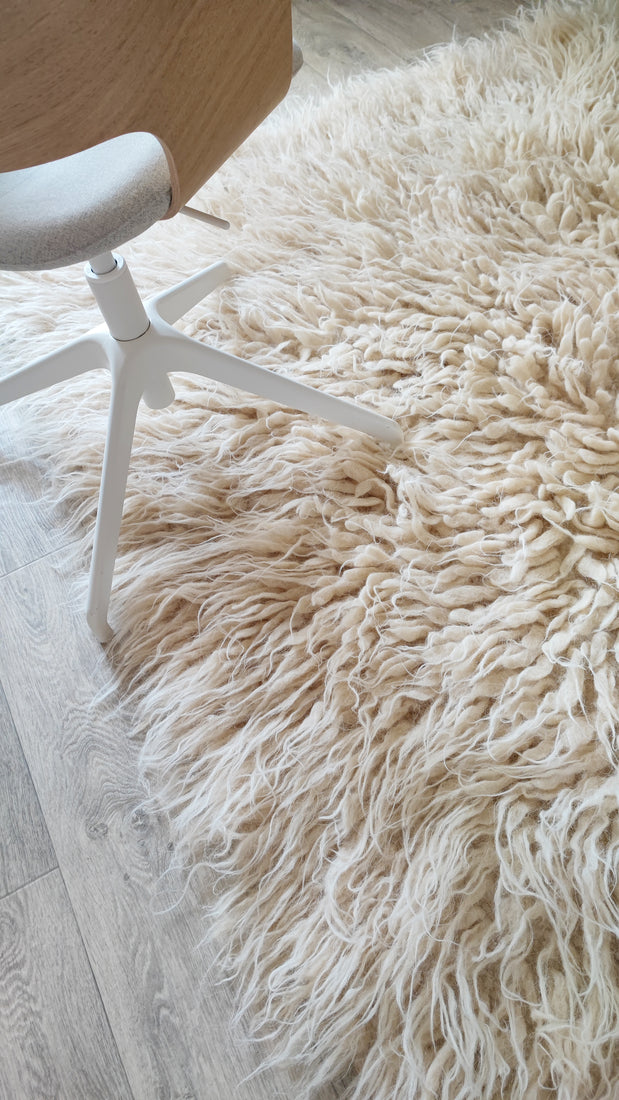 Thick-pile wool flokati rug in ivory white, soft cascading texture, traditional Ukrainian craftsmanship