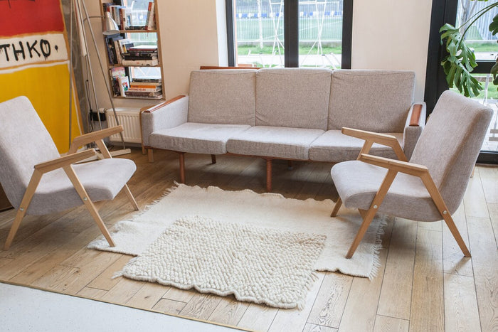 Hand-knotted ivory wool rug with contrasting smooth and looped wool panels, an artisan study in texture and geometry