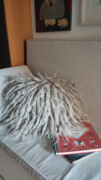 Light grey flokati wool pillow with long textured shags