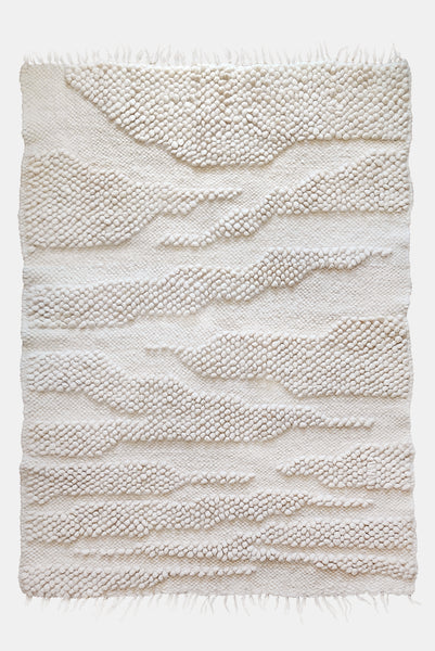 Natural undyed wool rug, ivory-on-ivory abstract design with organic ridge texture inspired by mountain ranges
