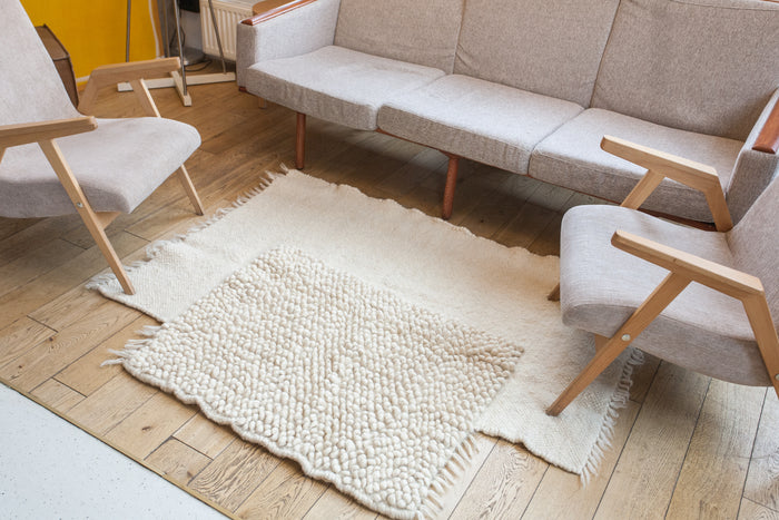 Contemporary minimalist wool rug, ivory-on-ivory geometric panel design, handcrafted using traditional Ukrainian weaving techniques