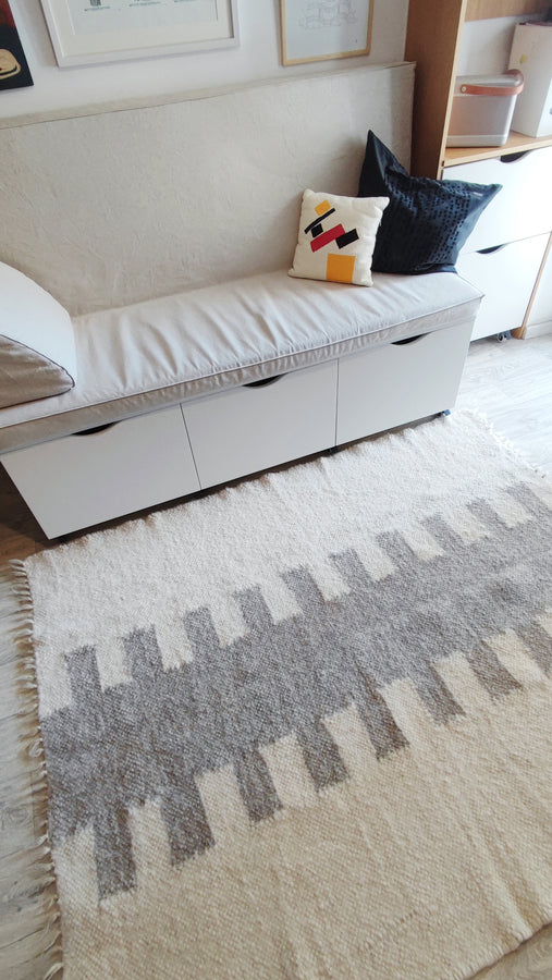 Contemporary wool rug featuring an ethnic-inspired vertical motif, handcrafted from natural sheep wool, ivory base with customizable accent tones