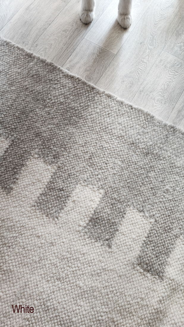 Handwoven wool rug featuring a bold central geometric stripe, ivory and gray colorway, Southwestern-inspired minimalist design