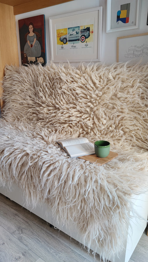 Natural sheep wool flokati rug, available in ivory, light gray, or dark gray, deep tactile shag texture, handcrafted
