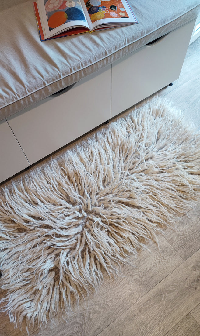 Shaggy wool area rug, light gray tone with ivory-white tufted strands, handmade from natural undyed wool

