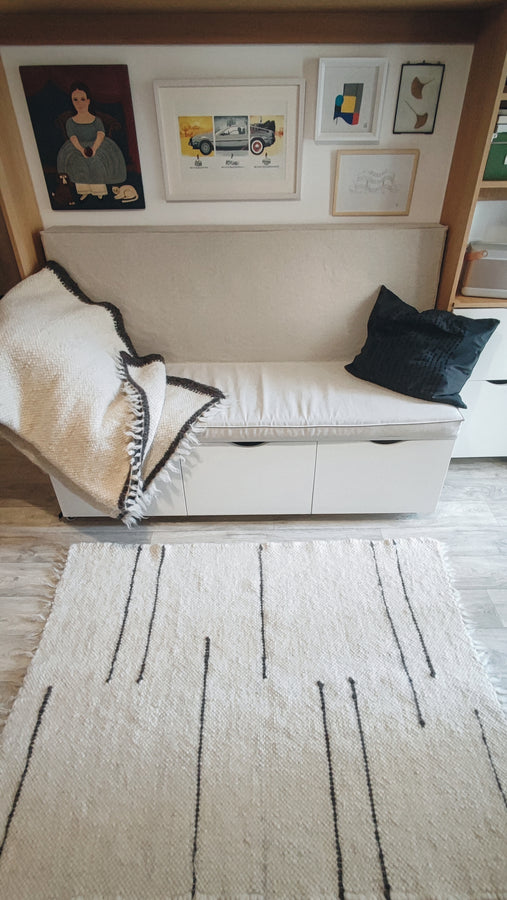 Strypa rug — contemporary minimalist wool rug, ivory and black stripe design, traditional Ukrainian craftsmanship