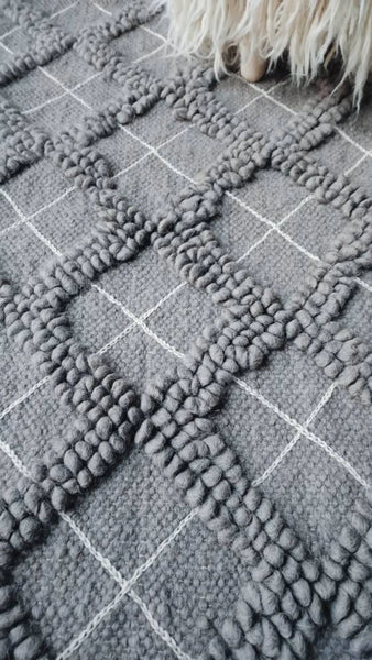 Sula gray rug — handwoven wool rug with sculptural diamond bobble texture and contrasting hand-embroidered diamond accents
