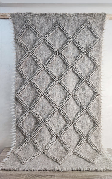 Tern grey rug — handwoven wool rug with sculptural big diamond bobble texture and contrasting hand-embroidered diamond accents