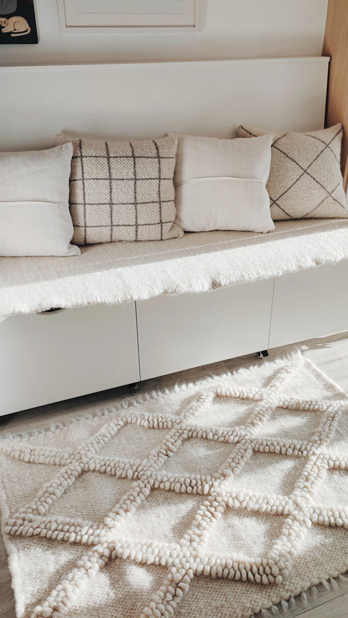 Tone-on-tone ivory wool rug featuring nested diamond pattern, hand-knotted using traditional bobble-weave (gulky) technique