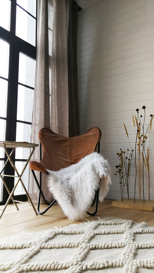 Natural undyed wool rug with raised diamond relief texture, monochromatic ivory white design, handcrafted heritage piece