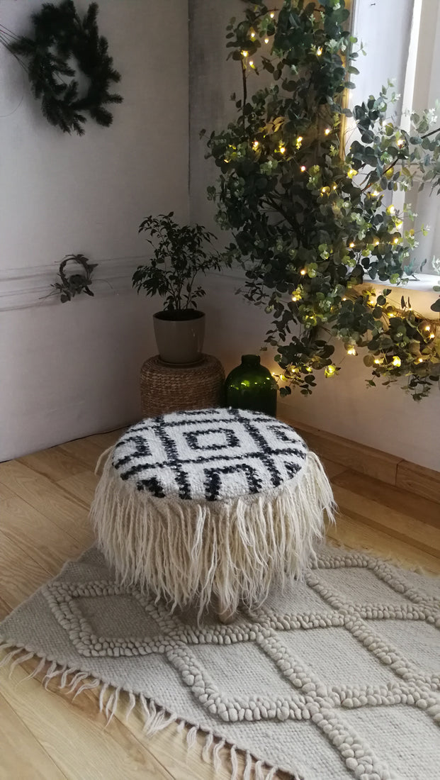 Sculptural ivory wool rug, diamond motif created through traditional looped weaving, a refined statement piece