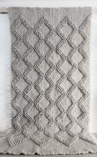 Natural undyed wool rug featuring subtle bobble-woven diamonds in matching tone, light gray colorway, handcrafted using traditional techniques