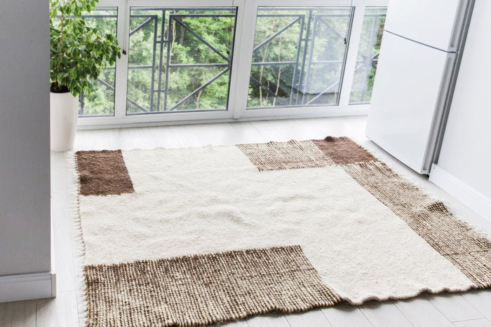 Handwoven wool rug, ivory and brown overlapping square pattern, a minimalist design rooted in Ukrainian textile heritage