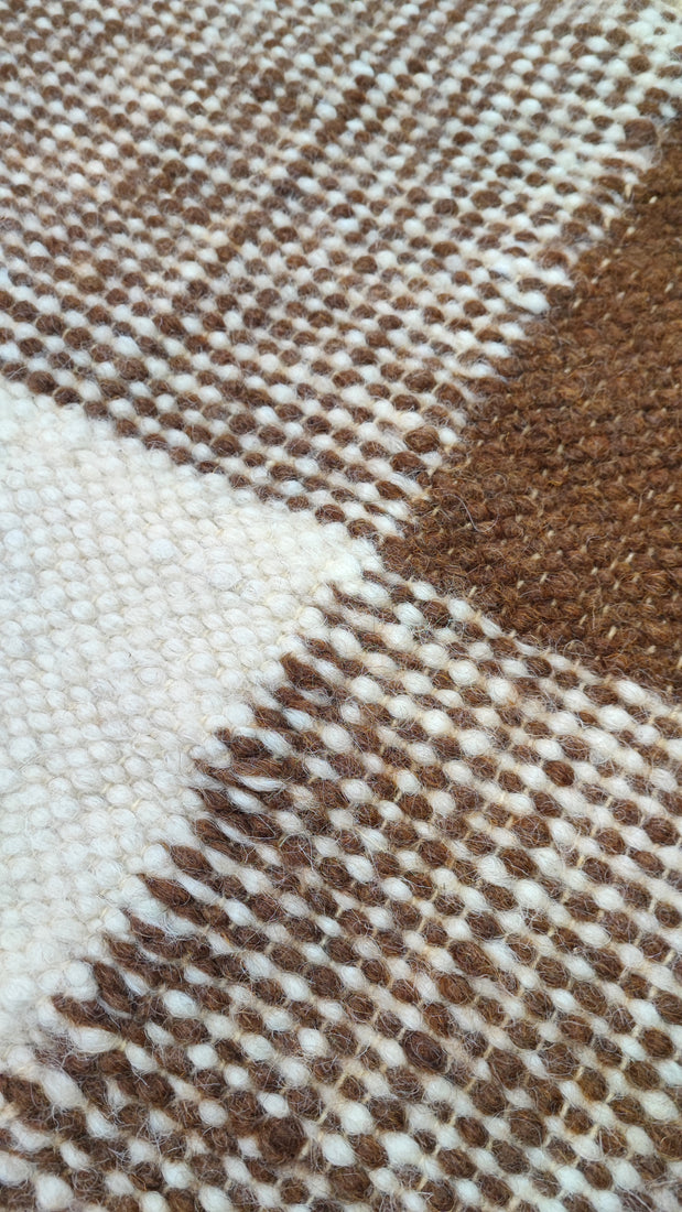 Uday rug — minimalist flat-weave wool rug with brown squares layered over ivory white, authentic artisan craftsmanship