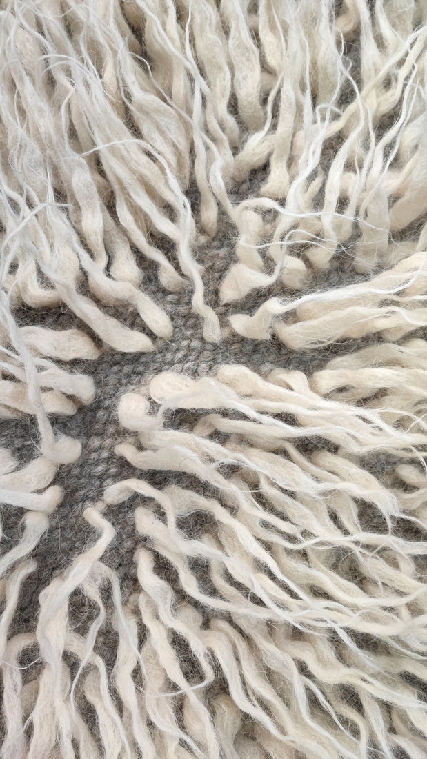 Close-up of textured white fabric with frayed edges