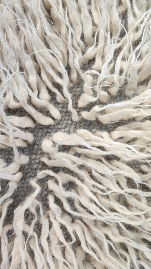 Close-up of textured white fabric with frayed edges