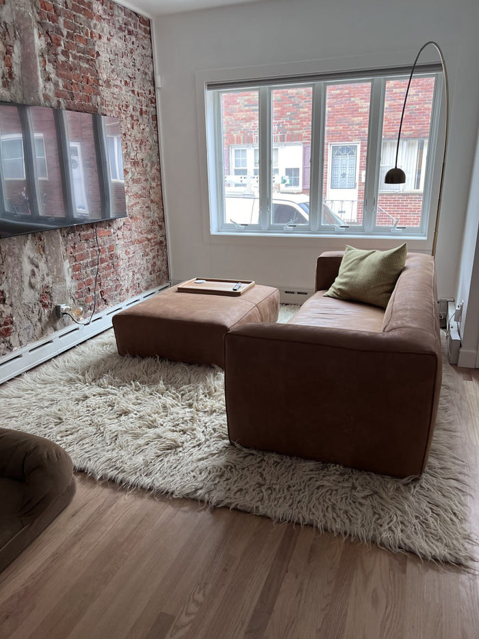 Natural sheep wool flokati rug, available in ivory, light gray, or dark gray, deep tactile shag texture, handcrafted
