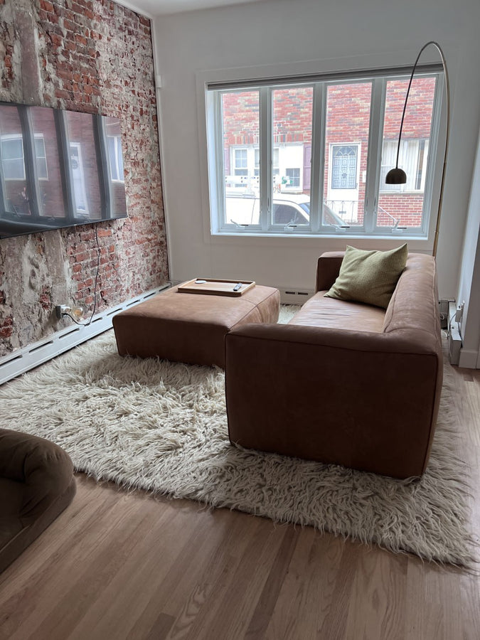 Natural sheep wool flokati rug, available in ivory, light gray, or dark gray, deep tactile shag texture, handcrafted