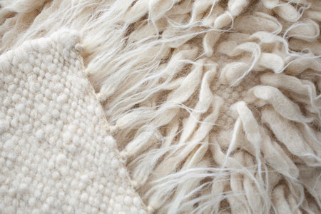 Vovnya rug — shaggy ivory white wool rug with cascading ivory tufts, a tactile statement piece for minimalist interiors