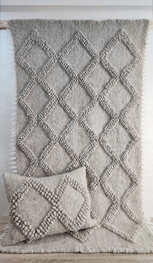 Tern gray rug — minimalist wool rug with intricate textured diamond geometry, handmade using centuries-old Ukrainian weaving methods with decorative pillow