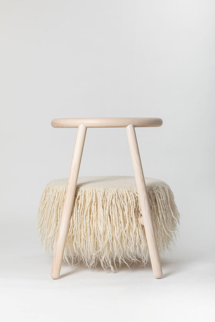 Modern white armchair in bright Scandinavian-style interior