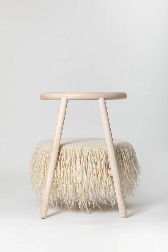 Back view of the white Mapico accent chair in a bright Scandinavian-style interior