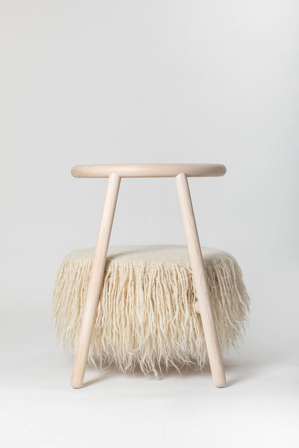Modern white armchair in bright Scandinavian-style interior