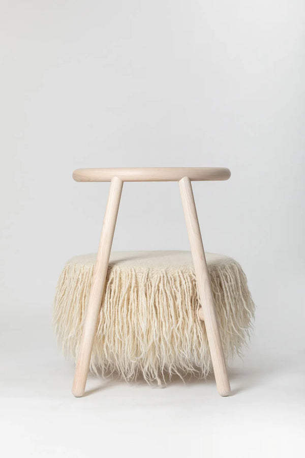 Back view of the white Mapico accent chair in a bright Scandinavian-style interior
