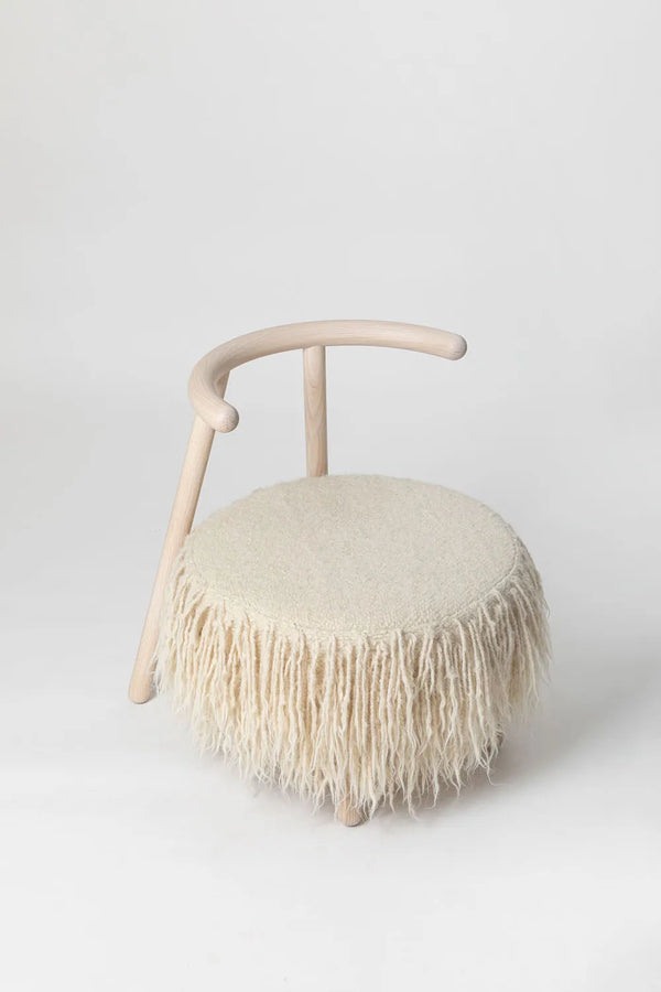 White Mapico accent chair on a minimalist white backdrop