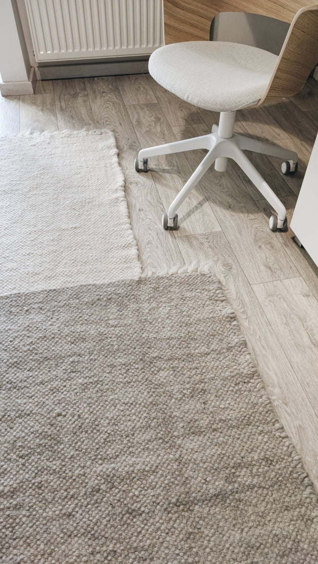 Hand-knotted wool rug, asymmetric block design in ivory, dark gray, and light gray tones, contemporary minimalist craftsmanship