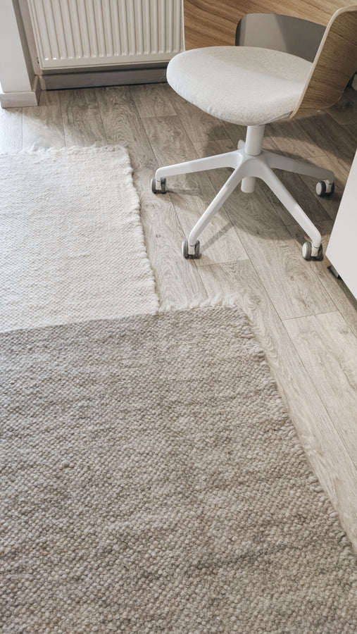 Hand-knotted wool rug, asymmetric block design in ivory, dark gray, and light gray tones, contemporary minimalist craftsmanship