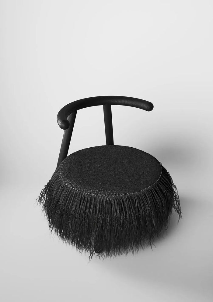 Black Mapico accent chair with matte finish in a loft-style interior