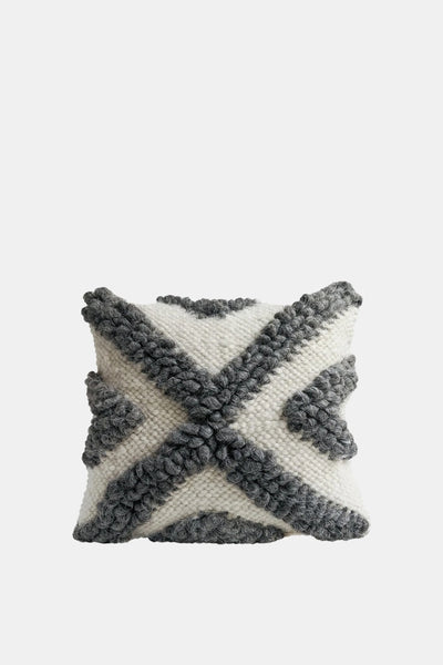 Chaga wool pillow with black and grey bobble pattern on smooth wool base