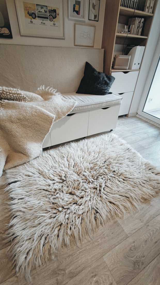 Vovnya rug — fluffy ivory white flokati rug, long-pile wool texture, a cozy minimalist statement for refined interiors