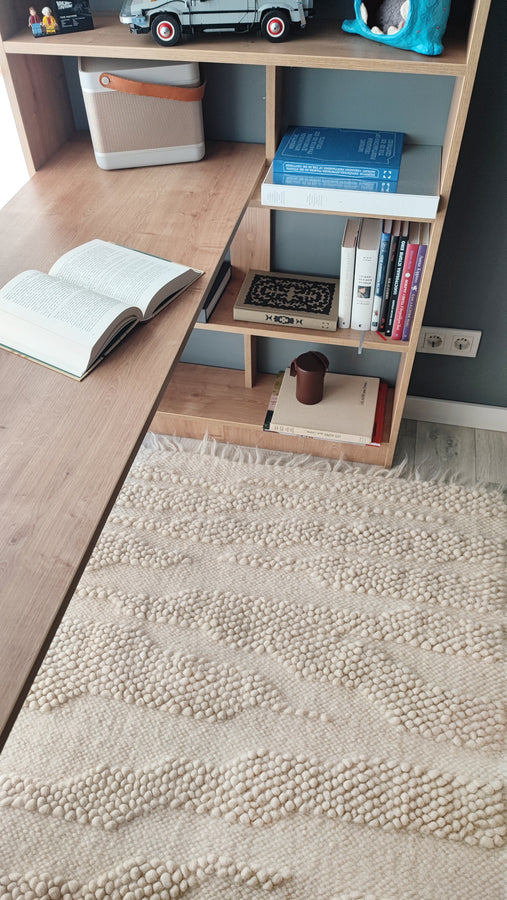Three-dimensional ivory white wool rug, nature-inspired abstract design, handcrafted using traditional Ukrainian weaving techniques