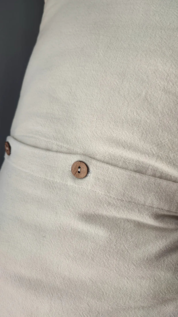 Close-up of Mapico linen pillow with wooden button closure detail