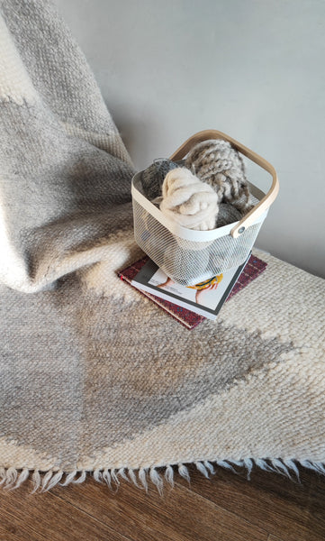 Handmade wool rug in ivory white with light gray diamond pattern, traditional Ukrainian-inspired design