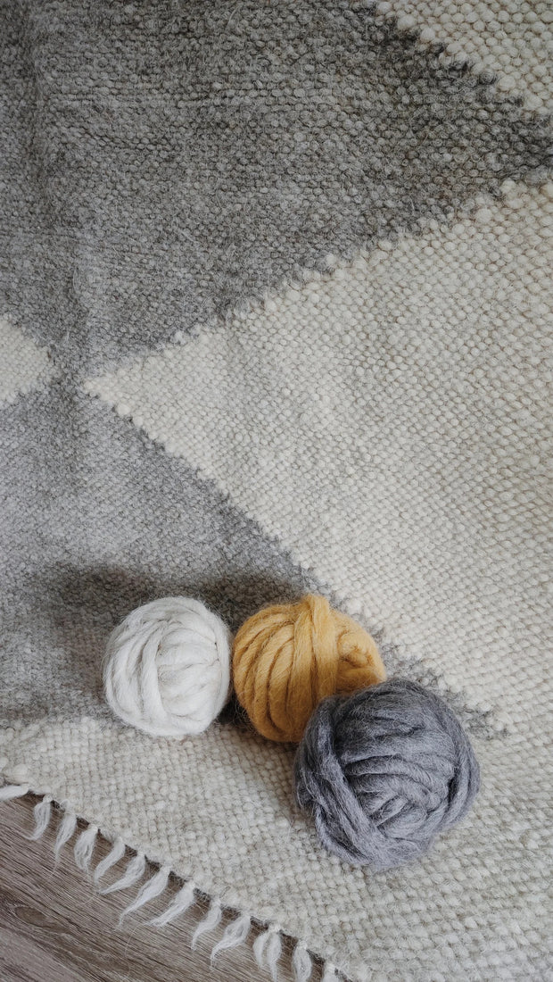 Lukva rug — minimalist wool rug with ivory white and light gray diamond motif, rooted in Ukrainian textile heritage