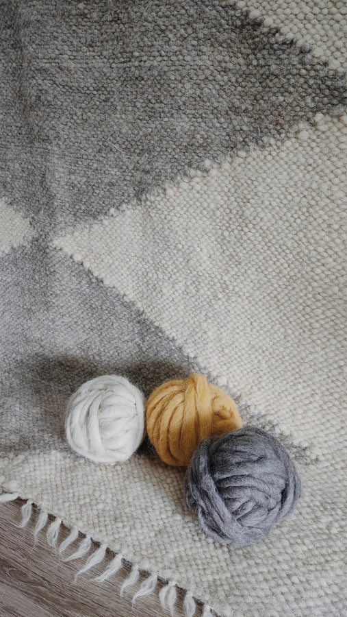 Lukva rug — minimalist wool rug with ivory white and light gray diamond motif, rooted in Ukrainian textile heritage
