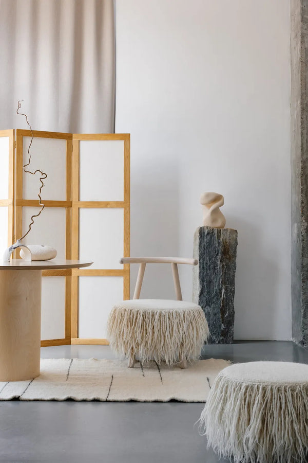White Mapico accent chair styled in a minimalist living room corner