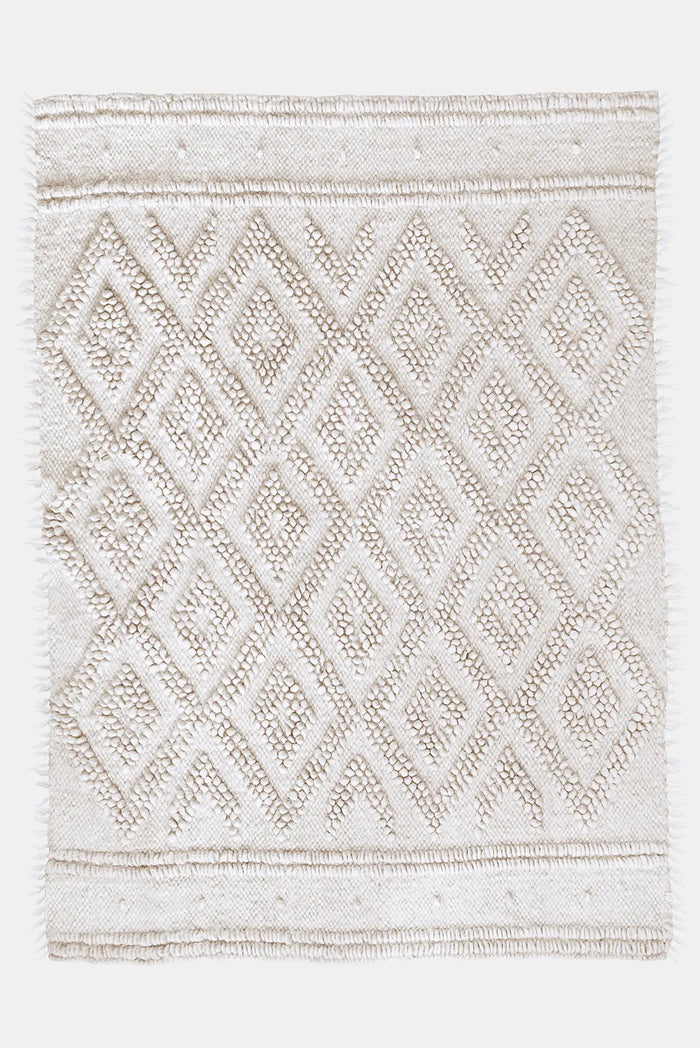 Melanka rug — handwoven ivory white wool rug with sculptural double-diamond texture, flagship design from traditional Ukrainian craftsmanship