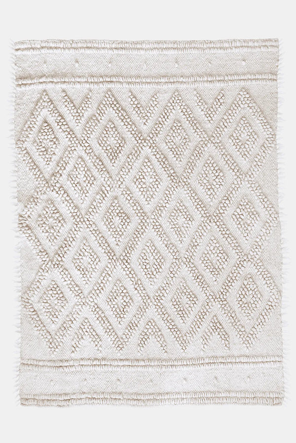 Melanka rug — handwoven ivory white wool rug with sculptural double-diamond texture, flagship design from traditional Ukrainian craftsmanship