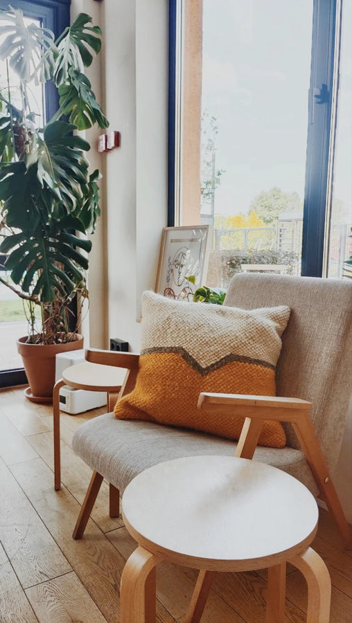 Olava wool decorative pillow styled in a minimalist living room interior