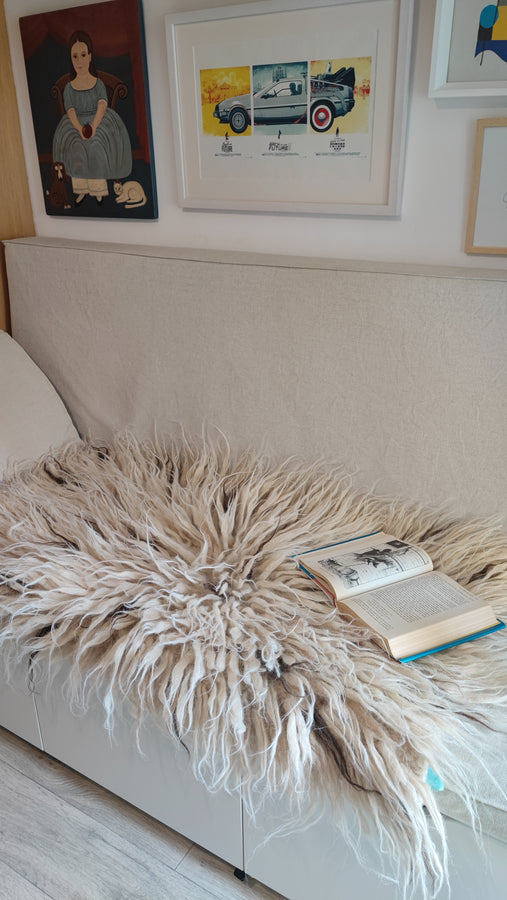 Handmade shaggy wool rug, ivory white pile accented by scattered beige and brown wool flecks, traditional craftsmanship