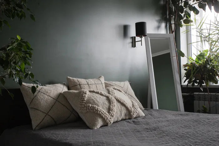 Tern wool pillows styled on a bed alongside other Mapico cushions