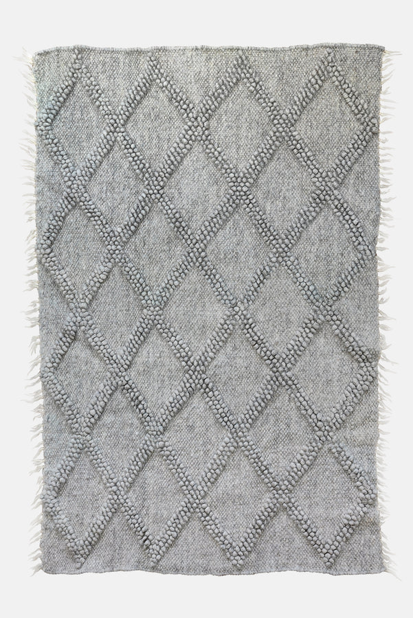 Tern grey rug — handwoven wool rug with sculptural big diamond bobble texture and contrasting hand-embroidered diamond accents